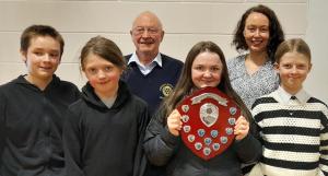 Pictured are the winning team with their trophy, their teacher and Dale Hatton, Rotary quizmaster.

